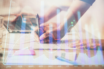 Multi exposure of woman hands typing on computer and financial chart hologram drawing. Stock market...