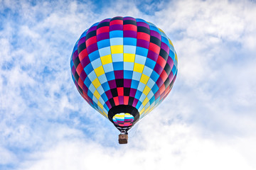 Single, colorful  hot-air balloon high in the sky