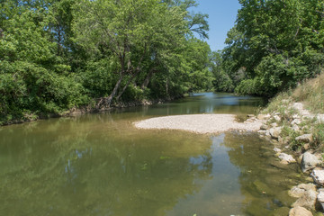 Fototapeta na wymiar a creek with green tinted water