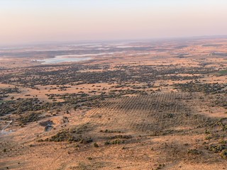 Hot air balloon flight at sunrise, Aerial View over the great Alqueva lake, in Alentejo, Portugal