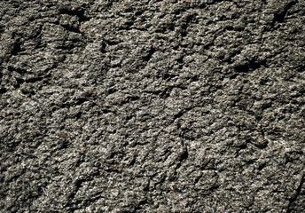 Rough dark stone texture. Natural grunge background close-up.