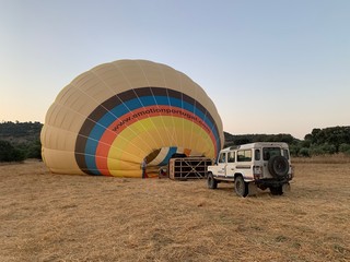 Monsaraz, Alentejo / Portugal - July 12 2020: Hot air balloon flight in a dry field of Alentejo at sunrise, Portugal