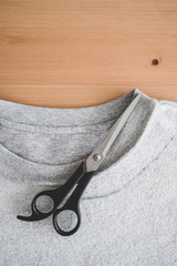 upcycling old clothes concept, sweatshirt with scissors to cut a new neckline