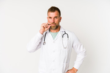 Senior doctor man isolated on white background with fingers on lips keeping a secret.