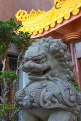 stone lion statue in traditional style at the entrance of a Buddhist temple