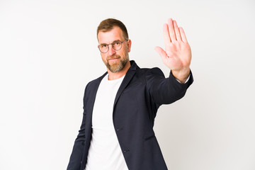 Senior business man isolated on white background standing with outstretched hand showing stop sign, preventing you.