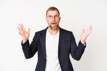 Senior business man isolated on white background receiving a pleasant surprise, excited and raising hands.