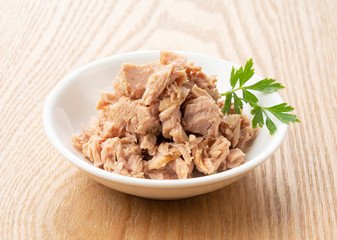 Tuna and Italian parsley on a wooden background