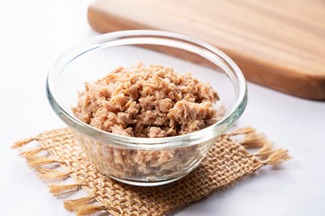 Tuna in a glass bowl set in a marble