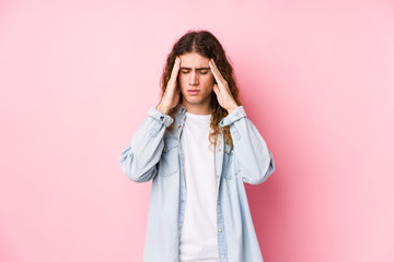 Long hair man posing isolated touching temples and having headache.