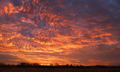 Orange sunset over open field