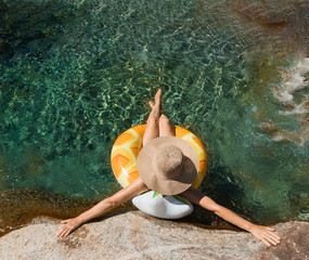 woman with pamela on a float on a mountain river