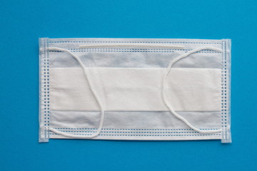 Medical mask or surgical earloop face mask on blue background