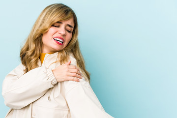 Young blonde caucasian woman having a shoulder pain.