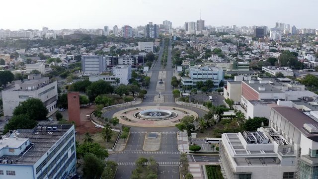 Impressive establishing city skyline view of empty and desolate Center of Heroes park and monument, Santo Domingo, Dominican Republic, coronavirus pandemic and restriction, overhead aerial approach