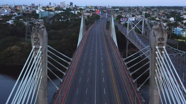 Covid-19 pandemic empty and desolate Puente Juan Pablo Duarte bridge and highway lanes, Santo Domingo, Dominican Republic, coronavirus restriction, overhead rising aerial drone