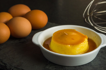 Traditional Brazilian dessert, milk pudding on dark background.