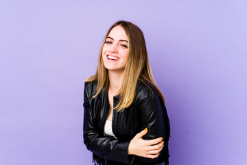 Young caucasian woman isolated on purple background laughing and having fun.