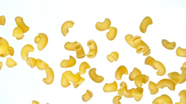 Super slow motion of flying uncooked italian pasta gobetti on white background. Filmed on high speed cinema camera, 1000 fps.