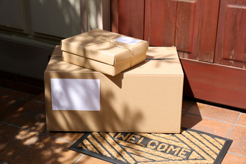 Delivered parcels on door mat near entrance