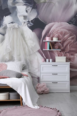 Teenage girl's room interior with comfortable bed and floral wallpaper. Idea for stylish design © New Africa