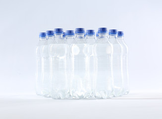 Plastic bottles with pure water on white background