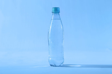 Plastic bottle of pure water on color background