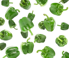 Fresh green bell peppers falling on white background