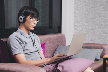 Businessman meeting online via video call on laptop in home office. Man wear headphone video...