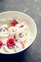 Healthy and tasty breakfast with curd, sour cream, raspberry and honey. Selective focus.
