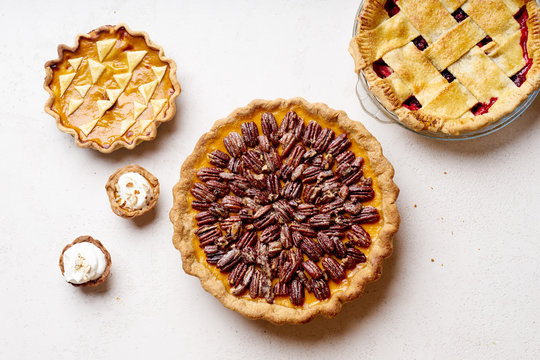 Variety of thanksgiving pies with berries, pumpkin and pecan