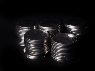 Pile of coins isolated on black background