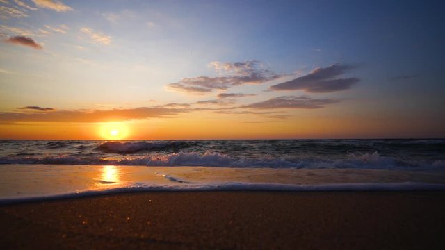 Tropical sea sunrise and waves on exotic beach