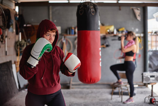 Determined sportswoman shadow boxing in gym