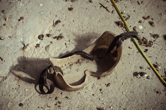 From above of dusty protective plastic glasses placed on shabby concrete floor of abandoned plant