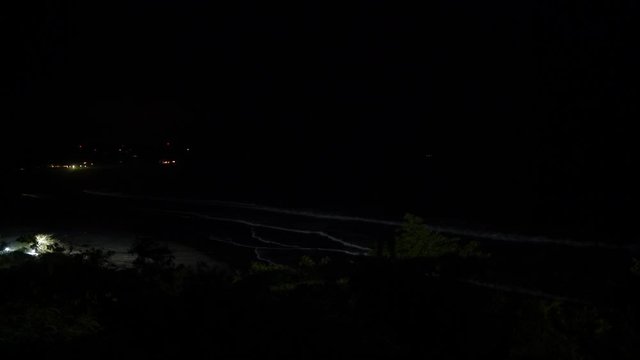 Thunderstorm lights on a tropical beach at night