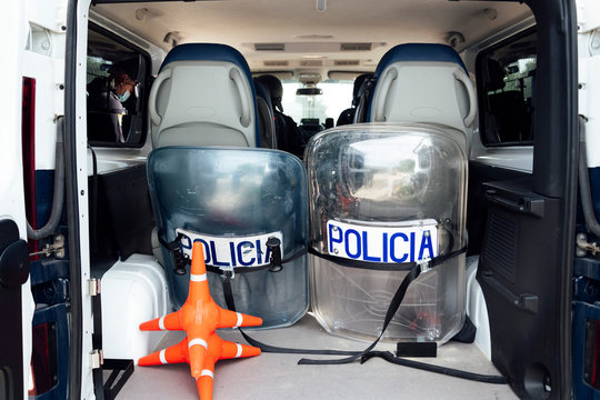 Set of protective shields and traffic equipment placed in truck of police van parked on street in daytime