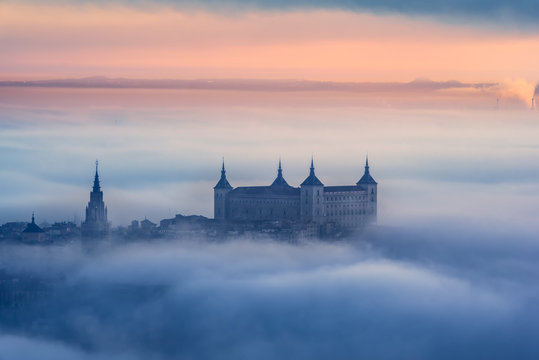 From above wonderful landscape of medieval castle built over city in misty colorful sunset