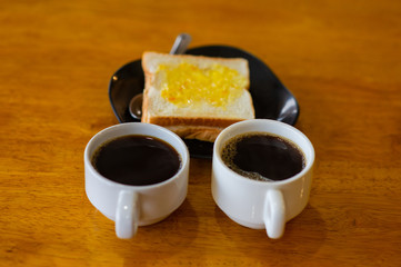 Cup of coffee and buttered toast