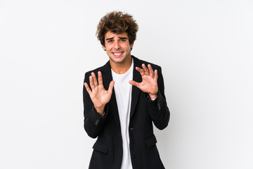 Young caucasian business man against a white background isolated rejecting someone showing a...