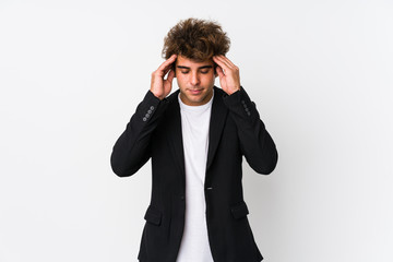 Young caucasian business man against a white background isolated touching temples and having...