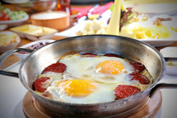 sliced sausages fried with egg