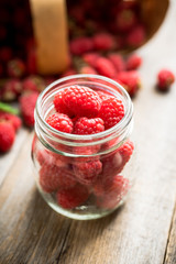 Ripe juicy raspberries in jar. Selective focus. Shallow depth of field.
