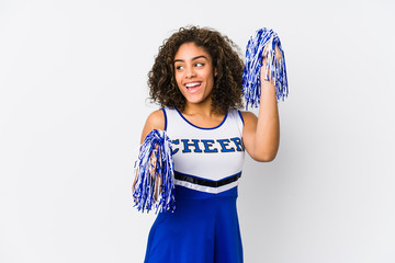 Young cheerleader woman isolated on white background