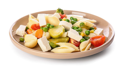 Plate with tasty conchiglie pasta and vegetables on white background