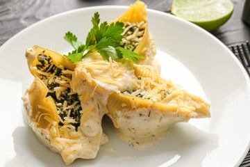 Plate with tasty conchiglioni pasta, closeup