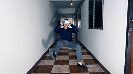 The young man happily watched a movie through a 3D camera in front of his room.