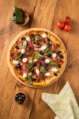 Flat lay with pizza and its ingredients