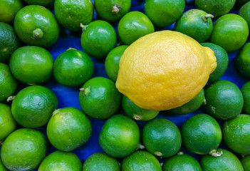 The yellow lemon stands out from the other green lime on the market.