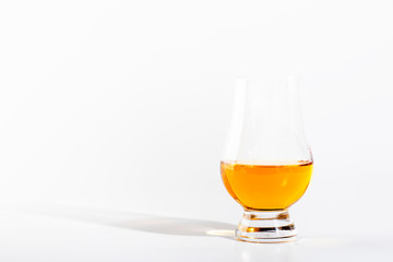Scotch Whiskey without ice in glass, white background, copy space